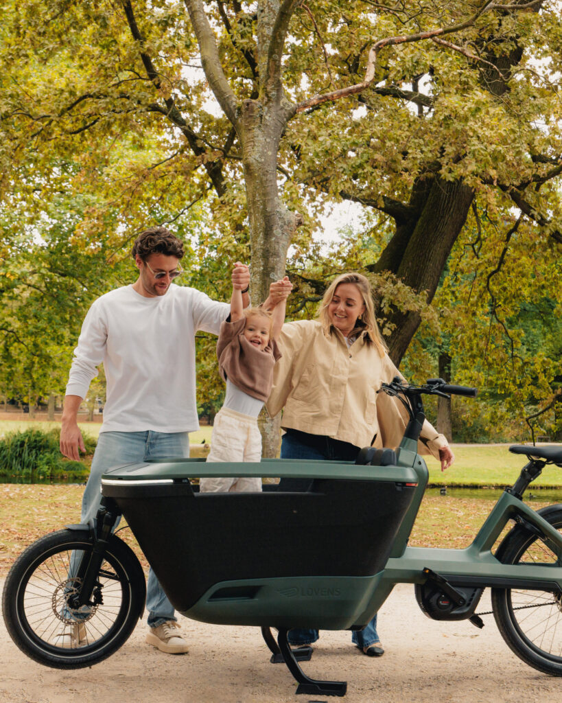 Family standing with their Lovens Explorer 2 cargo bike enjoying a day in the park